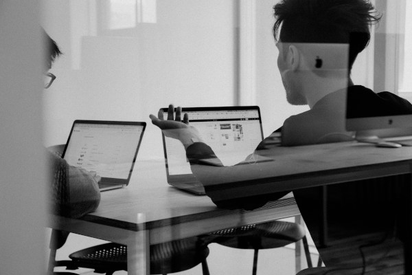 Pair of people working on computers in an office
